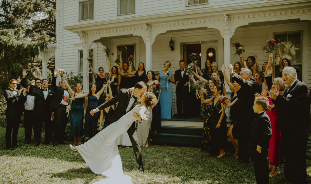 Nicole and Davis kiss in front of family on their wedding day